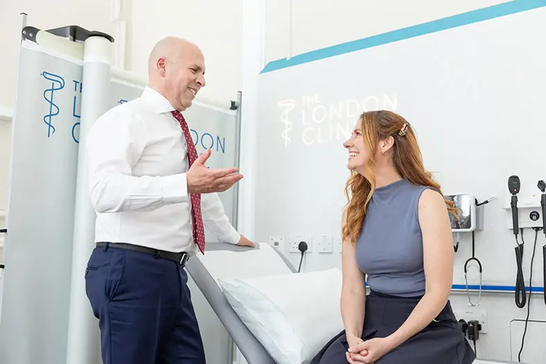 Thymoma 12 Thoracic surgeon discussing alternatives to surgery with patient in consultation